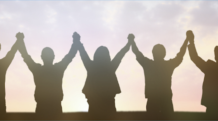 silhouette of people holding hands in a long chain