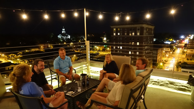 people on rooftop at night relaxing