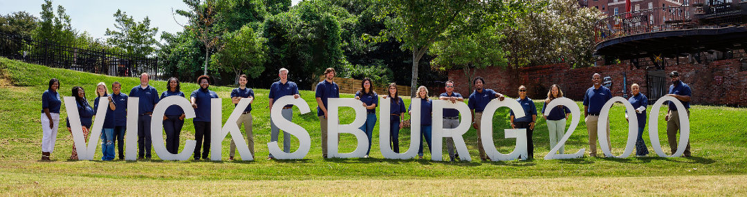 People holding Vicksburg 200 letters