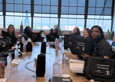 class of students holding gift bags